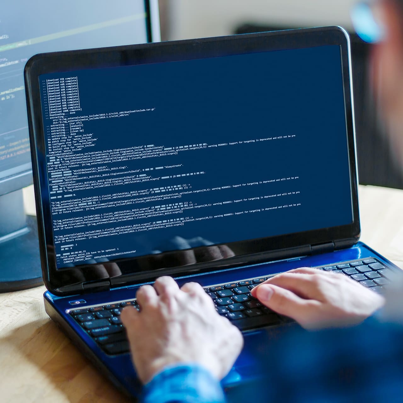 Armada Power About Us Landing Page Featured Image - Man Coding at a Laptop